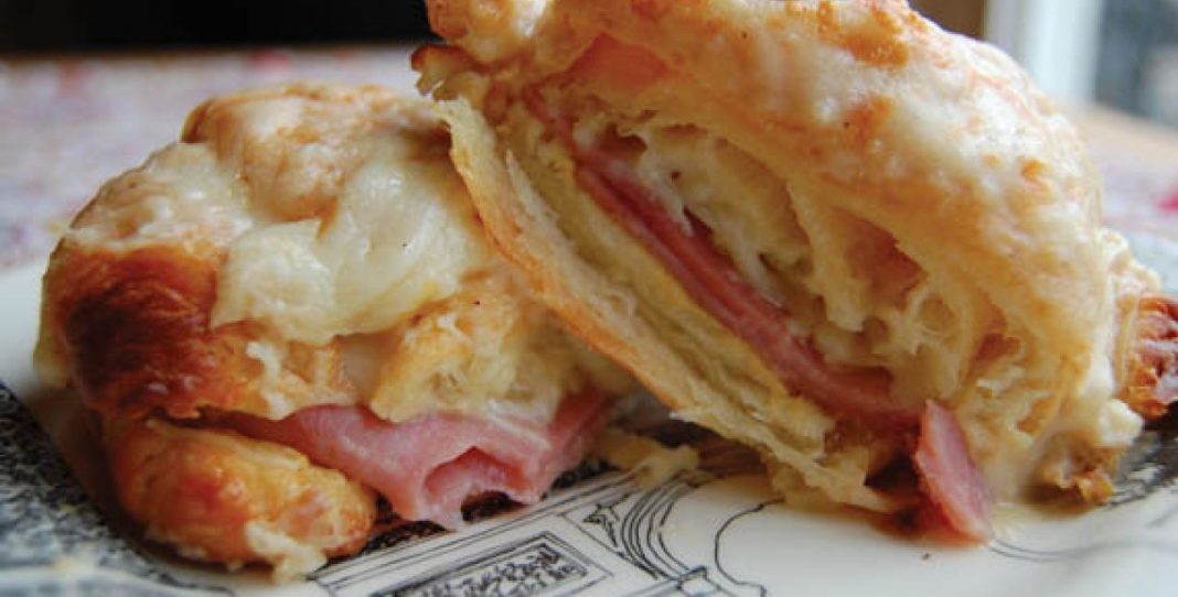 Φωτογραφία ενός χρυσαφένιου Κροκ Μεσιέ με λιωμένο τυρί να ξεχειλίζει.