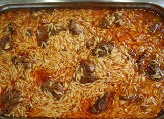 Ένα πήλινο σκεύος με ζουμερό γιουβέτσι μοσχάρι, μελωμένο κριθαράκι και κόκκινη σάλτσα, πασπαλισμένο με κεφαλοτύρι