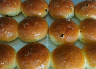 Ένα ταψί με χρυσαφένια, στρογγυλά σταφιδόψωμα.