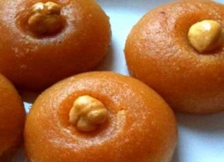 Σειρές από χρυσαφένια σιροπιαστά Σεκερ Παρέ με ένα ολόκληρο φουντούκι στο κέντρο τους, λουσμένα σε λαμπερό σιρόπι