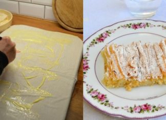 Μια χρυσαφένια, τραγανή μπουγάτσα στιγμής κομμένη σε κομμάτια, πασπαλισμένη με άχνη ζάχαρη και κανέλα, σε ένα ταψί.