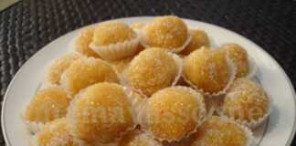 Τρούφες με μανταρίνι και αμύγδαλο, πασπαλισμένες με κρυσταλλική ζάχαρη, σερβιρισμένες σε χαρτάκια.