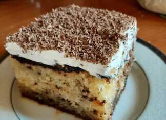 Λαχταριστό κομμάτι σιροπιαστό κέικ σοκολάτας με στρώση λευκής σαντιγί και γυαλιστερό γλάσο σοκολάτας.