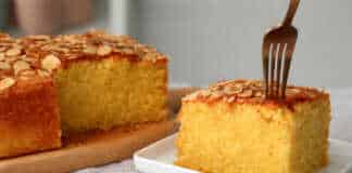 Ζουμερό και υγρό κέικ αμυγδάλου με πορτοκάλι, καλυμμένο με χρυσαφένιες νιφάδες αμυγδάλου σε τετράγωνο ταψί