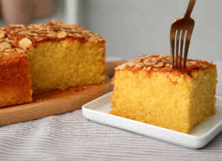 Ζουμερό και υγρό κέικ αμυγδάλου με πορτοκάλι, καλυμμένο με χρυσαφένιες νιφάδες αμυγδάλου σε τετράγωνο ταψί