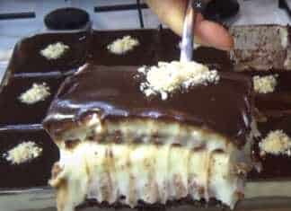 Κομμάτι πάστας με στρώσεις σοκολατένιου κέικ κρέμας και μπισκότων καλυμμένο με γυαλιστερή γκανάζ σοκολάτας και καρύδια