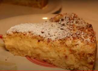 Τριφτή τούρτα με χρυσή τραγανή επιφάνεια και πλούσια στρώση κρέμας στο κέντρο πασπαλισμένη με άχνη ζάχαρη