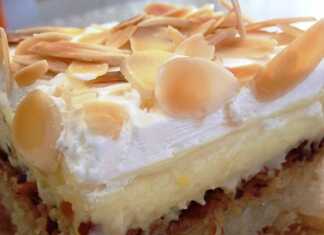 Ένα κομμάτι εκμέκ κανταΐφι με στρώσεις από σιροπιασμένο κανταΐφι, κρέμα και σαντιγί, πασπαλισμένο με αμύγδαλα.