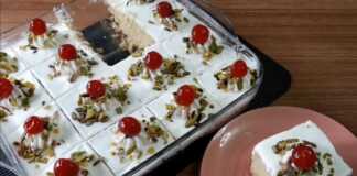 Ρεβανί με σαντιγί και φυστίκι αιγίνης Πλάνο από το σιροπιασμένο ρεβανί μέσα στο ταψί, με το σιρόπι να απορροφάται