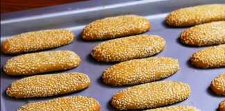 Ένα ταψί με χρυσαφένια, μακρόστενα κουλουράκια πασπαλισμένα με σουσάμι.