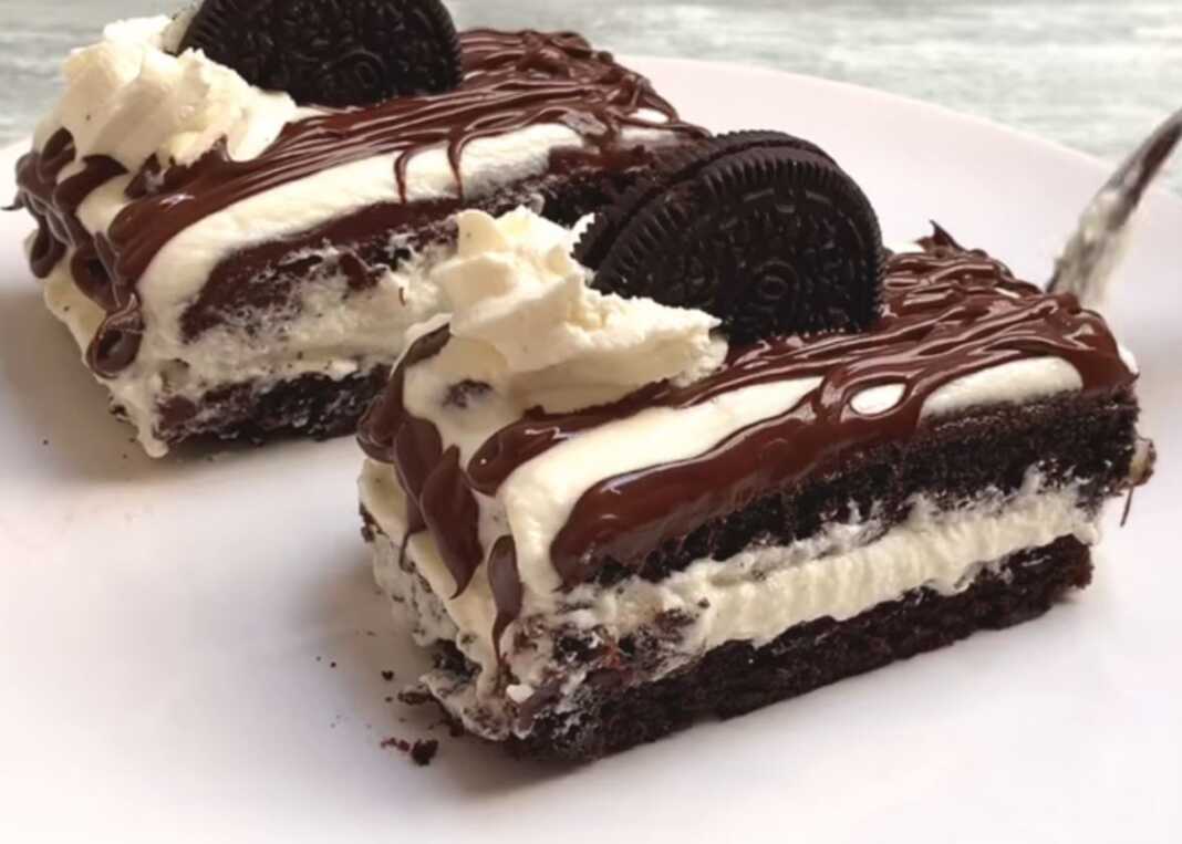 Λαχταριστή πάστα σοκολάτας με στρώσεις κρέμας και παντεσπάνι από μπισκότα Ορέο, διακοσμημένη με λιωμένη σοκολάτα