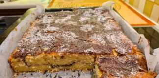 Το ψημένο **Αφράτο Κέικ Κανέλας** μέσα στο ταψί, πασπαλισμένο με κυβάκια