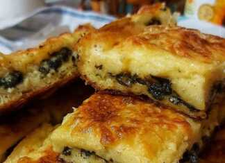 Τραγανή τσουκνιδόπιτα με φύλλο κρούστας στο ταψί, κομμένη σε τετράγωνα κομμάτια και ροδοκοκκινισμένη με κομματάκια βουτύρου