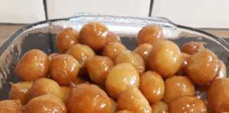 Χρυσαφένιοι σιροπιαστοί λουκουμάδες περιχυμένοι με σιρόπι και πασπαλισμένοι με κανέλα.