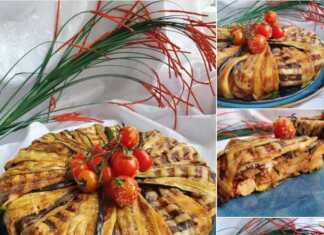 Τιμπάλ μελιτζάνας αναποδογυρισμένο σε πιατέλα, γαρνιρισμένο με ντοματίνια.