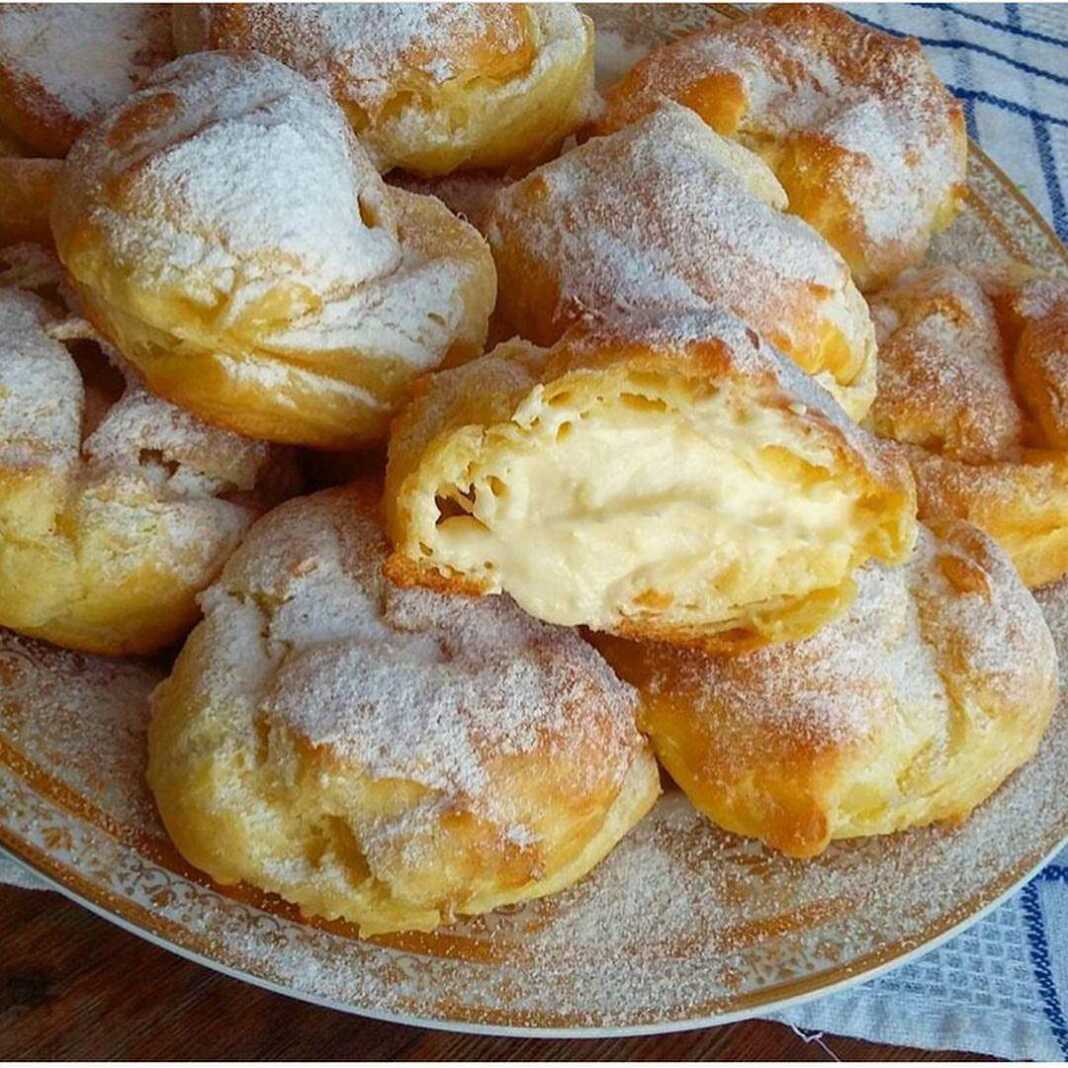 Πιάτο με αφράτα σουδάκια γεμισμένα με κρέμα, πασπαλισμένα με άχνη ζάχαρη ή περιχυμένα με σοκολάτα.