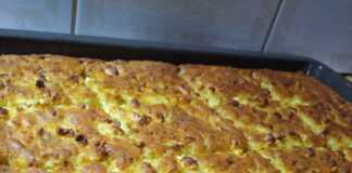 Ένα ταψι χρυσαφένιας κουρκουτόπιτας (μπατζίνας) με ορατά κομμάτια τριμμένου κολοκυθιού και φέτας.