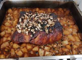 Χοιρινό μπούτι με πατάτες σε ταψί, ψημένο και έτοιμο να σερβιριστεί.