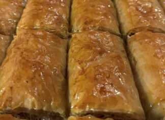 Παραδοσιακό Γιαννιώτικο Κανταΐφι Ένα ταψί με χρυσαφένια ρολά κανταΐφι, κομμένα σε μερίδες, με χοντροκομμένα καρύδια και αμύγδαλα στην επιφάνεια.