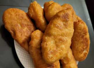 Τηγανισμένα πιροσκί με χρυσαφένια κρούστα, γεμιστά με πουρέ πατάτας, σε ένα πιάτο.