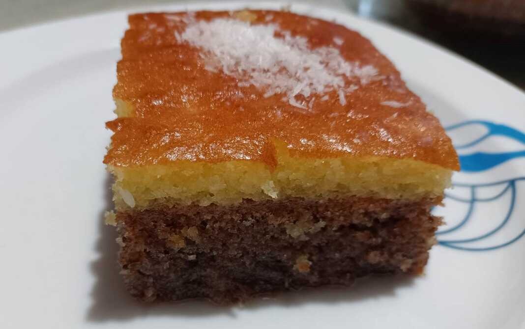 Λαχταριστή Καρυδόπιτα με Ρεβανί, σιροπιασμένη, κομμένη σε κομμάτια, με πλούσια υφή και αρώματα.