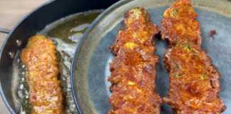 Χρυσαφένια τηγανητά κολοκυθάκια με τυρί, σερβιρισμένα σε πιατέλα.