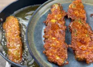 Χρυσαφένια τηγανητά κολοκυθάκια με τυρί, σερβιρισμένα σε πιατέλα.