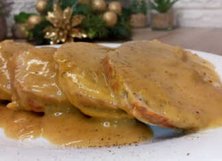 Λεπτές φέτες ζουμερού χοιρινού κρέατος βουτηγμένες σε μια παχύρρευστη αρωματική σάλτσα πορτοκαλιού, γαρνιρισμένες με φρέσκο θυμάρι