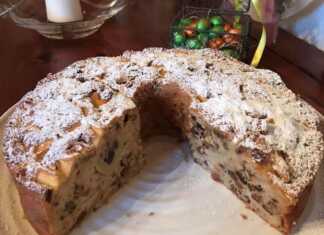 Αφράτο κέικ με μήλα, καρύδια και σταφίδες, πασπαλισμένο με ζάχαρη άχνη.