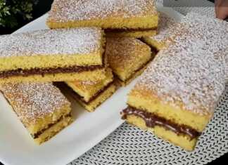 Κομμάτια κέικ ταψιού με γέμιση Nutella, πασπαλισμένα με ζάχαρη άχνη.