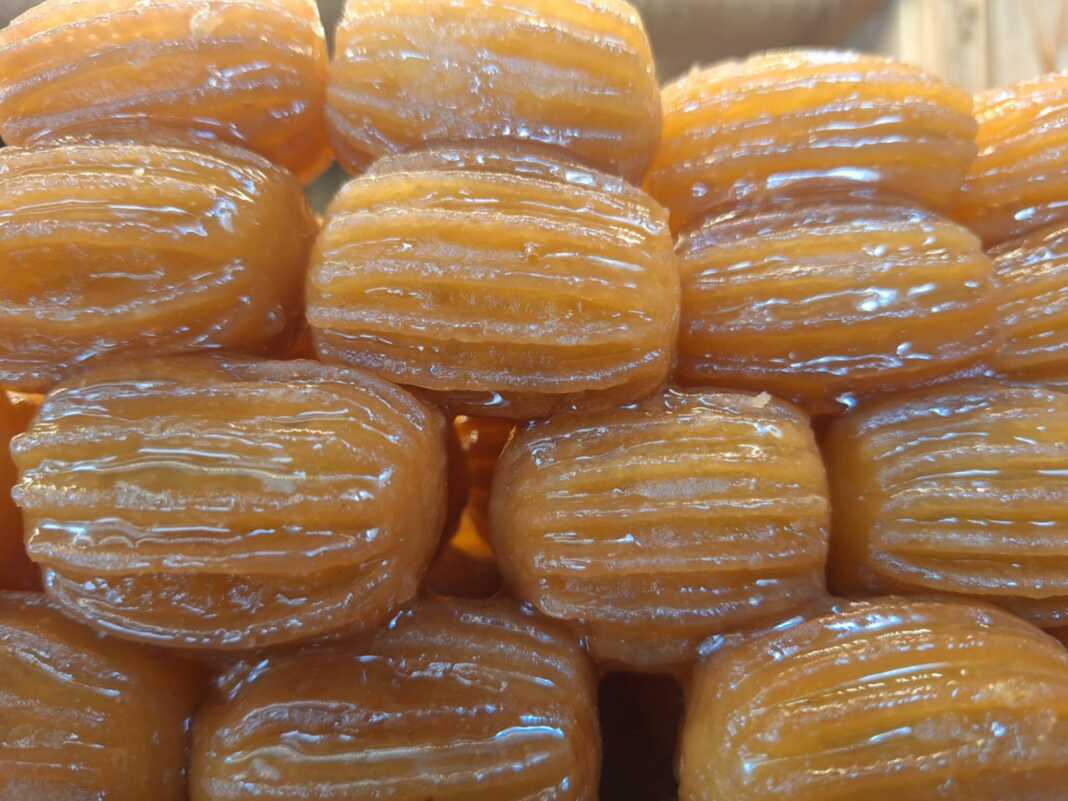 Μια πιατέλα γεμάτη χρυσαφένια, σιροπιαστά τουλουμπάκια.