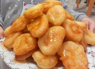 Χρυσαφένιες παραδοσιακές τηγανίτες σερβιρισμένες με μπόλικο μέλι και κανέλα σε ένα ρουστίκ πιάτο