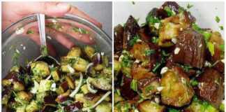 Ένα γυάλινο μπολ γεμάτο με κύβους μελιτζάνας μαριναρισμένους σε λάδι και ξύδι με ψιλοκομμένο σκόρδο άνηθο και φέτες κρεμμυδιού