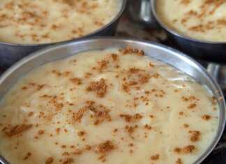 Ατομικά μπολάκια με λαχταριστό κρεμμώδες ρυζόγαλο πασπαλισμένα με μπόλικη κανέλα σε ξύλινο πάγκο