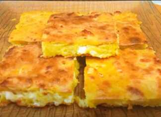 Παραδοσιακή ζυμαρόπιτα (αλευρόπιτα) με φέτα, κομμένη σε κομμάτια, με χρυσαφένια, τραγανή κρούστα.