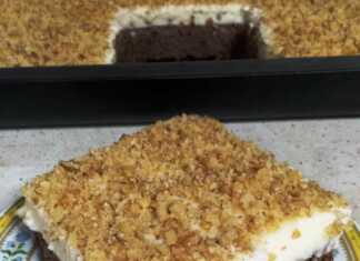 Τετράγωνο κομμάτι καρυδόπιτας με παχιά στρώση κρέμας πατισέρι από πάνω, πασπαλισμένη με τριμμένα καρύδια.