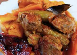 Ένα πιάτο με ζουμερό ραγού μοσχαριού και πολύχρωμα λαχανικά σε πλούσια σάλτσα.