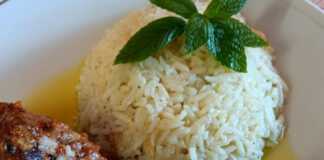 Ένα ταψί με κομμάτια ψητού χοιρινού που έχουν ροδίσει ωραία, σερβιρισμένα δίπλα σε ένα μπολ με λευκό ρύζι μπασμάτι.