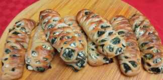 Σπανακοπιτάκια “Δίχτυ” με Αφράτη Ζύμη Εξι χρυσαφένια, φρεσκοψημένα σπανακοπιτάκια σε σχήμα πλεξούδας, τοποθετημένα σε λαδόκολλα, με ελαφρώς εμφανή τη γέμιση.