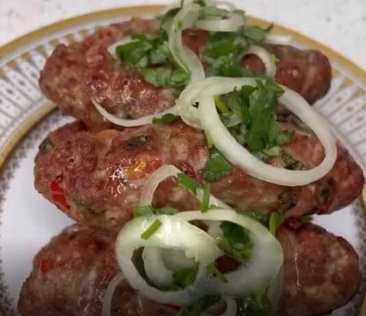 Καλοψημένα μακρόστενα κεμπάπ πάνω σε λαδόκολλα συνοδευόμενα από ψητές ντομάτες και αλάδωτες πίτες