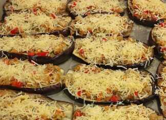 Ψητές μελιτζάνες φούρνου με ντομάτα και τυρί, με λιωμένη μοτσαρέλα και βασιλικό, έτοιμες για σερβίρισμα σε ένα ταψί