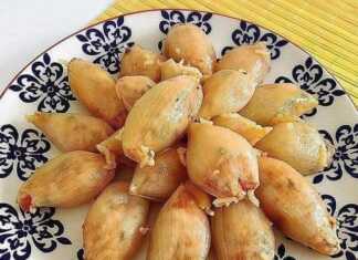 Παραδοσιακά Σουγάνια Μυτιλήνης, σερβιρισμένα σε πιάτο, με την ντοματένια σάλτσα και φρέσκο σχοινόπρασο.