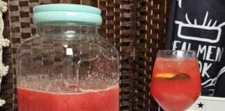 Δροσιστική σπιτική καρπουζάδα σε γυάλινη κανάτα, με φέτες καρπουζιού, παγάκια και φύλλα δυόσμου.