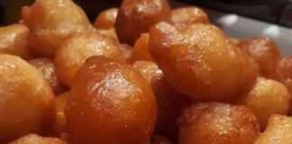 Τραγανοί Λουκουμάδες με Σιρόπι – Παραδοσιακή Συνταγή Μια πιατέλα γεμάτη με χρυσαφένιους, σιροπιαστούς παραδοσιακούς λουκουμάδες, περιχυμένους με μέλι.