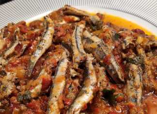 Μια πιατέλα με τηγανητό γαύρο με σάλτσα ντομάτας, πασπαλισμένο με φρέσκο μαϊντανό