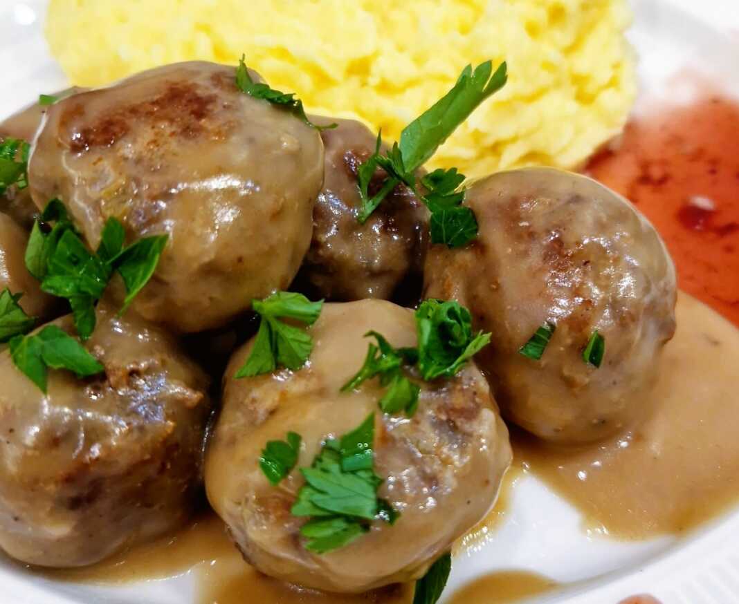 Μια πιατέλα με λαχταριστά, φρεσκομαγειρεμένα κεφτεδάκια περιχυμένα με πλούσια καφέ σάλτσα