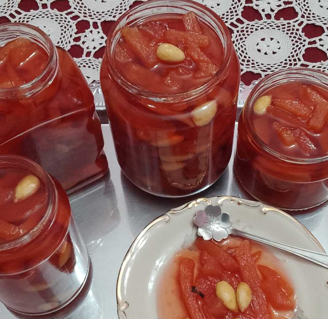 Γλυκό κουταλιού κυδώνι με κόκκινο χρώμα σε γυάλινο βάζο.