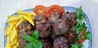 Πιάτο με χρυσαφένιους τηγανητούς κεφτέδες με ψιλοκομμένο δυόσμο και πατάτες τηγανητές