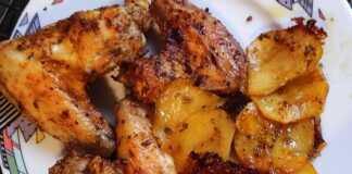 Χρυσαφένιες φτερούγες κοτόπουλου και λεμονάτες πατάτες ψημένες στο φούρνο, σερβιρισμένες σε ταψί