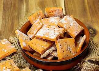 Τραγανά σπιτικά κρακεράκια σε τετράγωνα σχήματα, με κόκκινο χρώμα από την πάπρικα και τον κουρκουμά